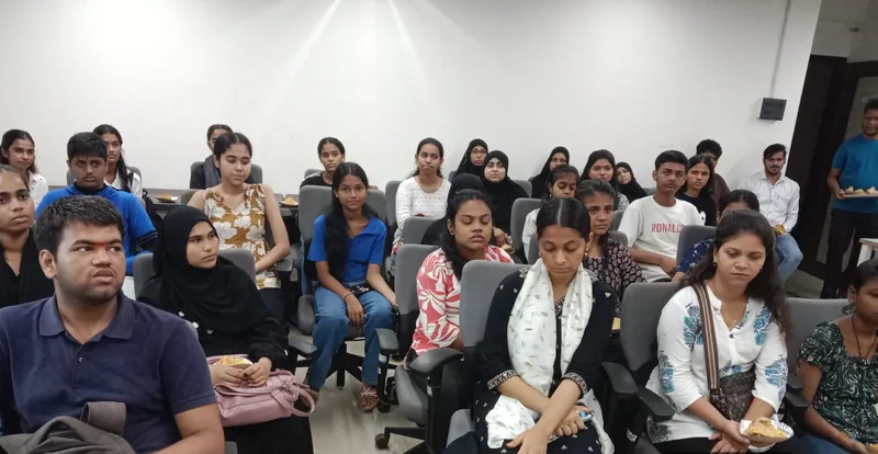 Young men and women seated in rows of chairs during a MindMints training session