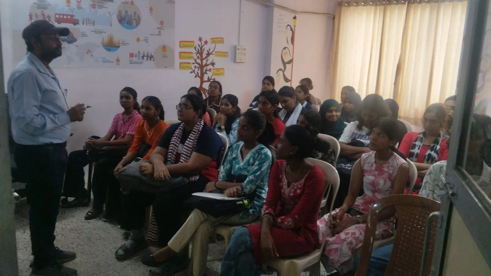 A MindMints trainer leading a classroom of young women during a skilling session